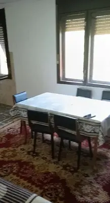 a mattress on a table in a room with two windows at Milutovac in Trstenik
