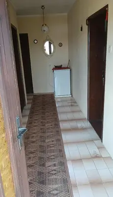 a hallway with a tile floor and a door at Milutovac in Trstenik