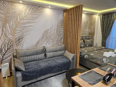 a living room with a couch and a bed at Bella vista KOP in Kopaonik