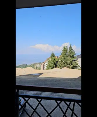 a window view of a beach with trees and sand at Bella vista KOP in Kopaonik