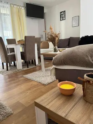 a living room with a couch and a table at Kovacevic Apartmani in Raška