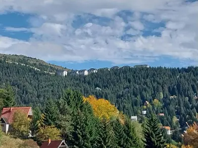 a view of a mountain with trees and houses at Kovacevic Apartmani in Raška