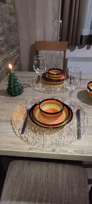 a table with plates and wine glasses on a table at Apartman LuPa in Kopaonik