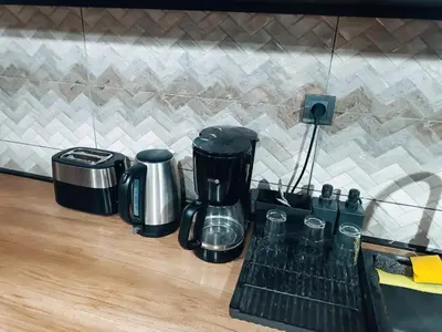 a counter with a coffee maker on a shelf at M Central Park in Niš