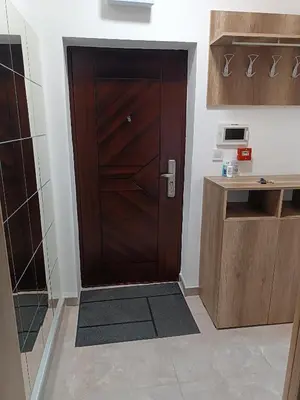 a wooden door in a kitchen with a counter at M Central Park in Niš