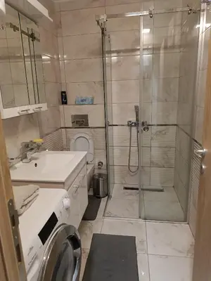 a bathroom with a shower and a sink and a toilet at M Central Park in Niš