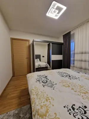 a bedroom with a large bed and a mirror at My happy place Vrnjačka Banja in Vrnjačka Banja