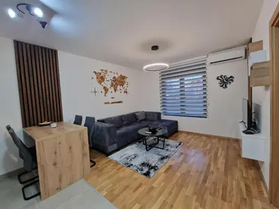 a living room with a couch and a table at My happy place Vrnjačka Banja in Vrnjačka Banja