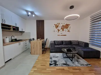 a living room with a couch and a table at My happy place Vrnjačka Banja in Vrnjačka Banja