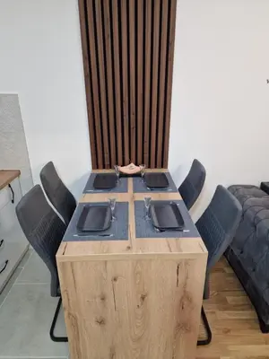 a wooden table with four chairs around it at My happy place Vrnjačka Banja in Vrnjačka Banja