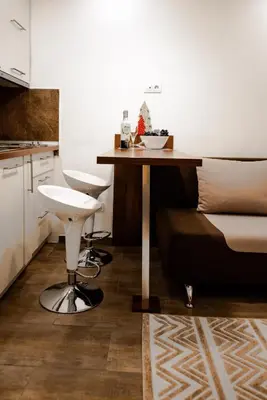a small kitchen with a table and a stool at Apartment Spust in Kopaonik
