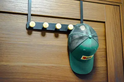 a baseball cap hanging from a wooden door at Apartment Spust in Kopaonik