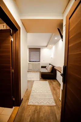 a living room with a couch and a door at Apartment Spust in Kopaonik