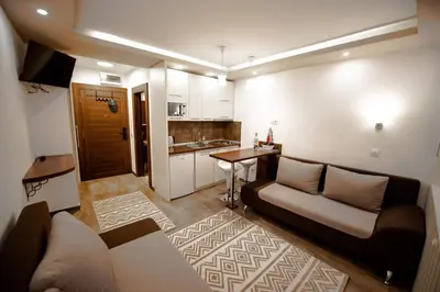 a living room with a couch and a table at Apartment Spust in Kopaonik