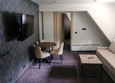 a living room with a table and chairs and a couch at Apartman Spust Angella in Kopaonik