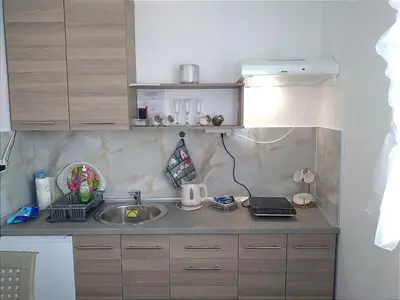 a kitchen with a sink and a laptop on a counter at Marta i Marija 2 in Vrnjačka Banja