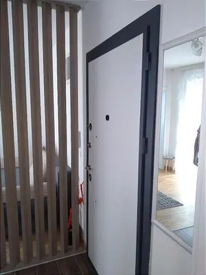 a door leading into a room with a crib at Marta i Marija 2 in Vrnjačka Banja