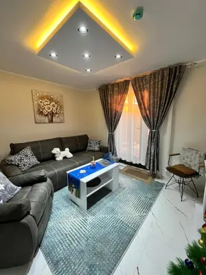 a living room with a couch and a table at Apartman Zimska idila in Kopaonik