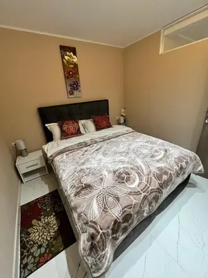 a bedroom with a large bed with a comforter at Apartman Zimska idila in Kopaonik