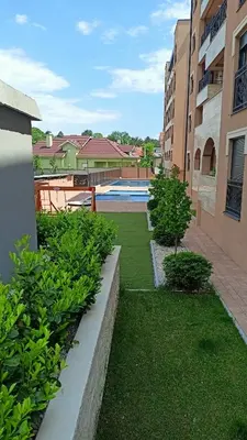 a courtyard with a swimming pool in a building at Larso Lux, free swimming pools & parking in Vrnjačka Banja