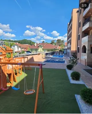 a view of a playground with a swing at Larso Lux, free swimming pools & parking in Vrnjačka Banja