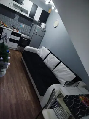 a bedroom with a bed with a black and white mattress at Apartman Sofi in Vrnjačka Banja