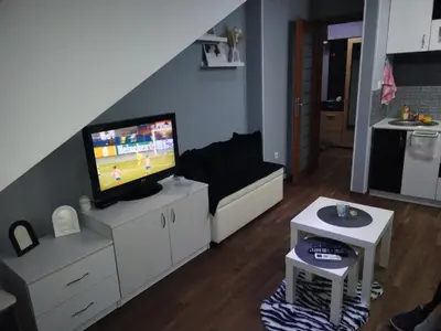 a living room with a flat screen tv on a cabinet at Apartman Sofi in Vrnjačka Banja