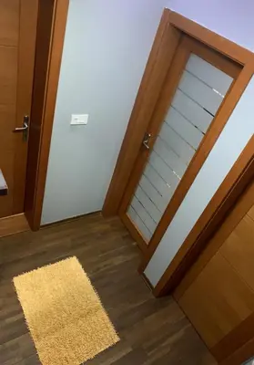 an empty room with a door and a rug at Apartman Sofi in Vrnjačka Banja