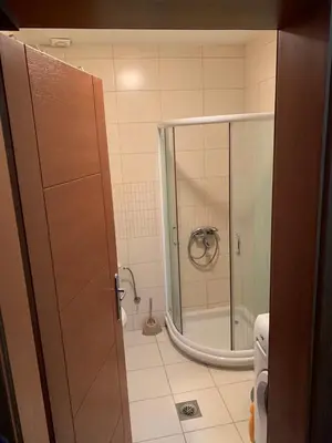 a bathroom with a shower with a glass door at Apartman Sofi in Vrnjačka Banja