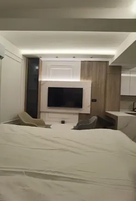 a bedroom with a bed and a flat screen tv at Pavlovic Luxury Spa in Vrnjačka Banja