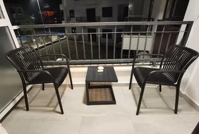 two chairs and a table on a balcony at Pavlovic Luxury Spa in Vrnjačka Banja
