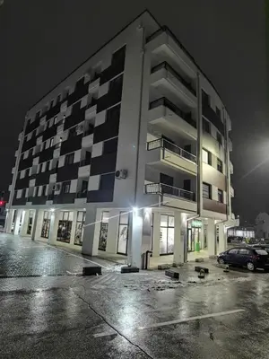 a large building at night with a parking lot at Pavlovic Luxury Spa in Vrnjačka Banja