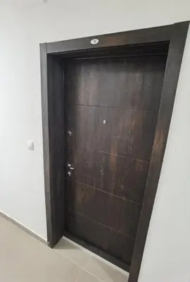 a wooden door in a room with a wall at Pavlovic Luxury Spa in Vrnjačka Banja