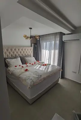 a bedroom with a bed with red roses on it at Pavlovic Luxury Spa in Vrnjačka Banja