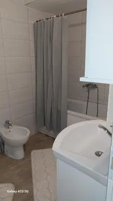 a bathroom with a sink and a toilet and a shower at Apartman Mina in Pirot