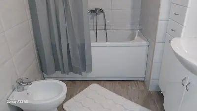 a bathroom with a toilet and a shower and a sink at Apartman Mina in Pirot