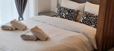 a bed with two pillows on top of it at Apartman Aska - Residence Hill in Kopaonik