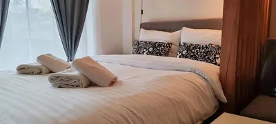 a bedroom with two beds with pillows and a window at Apartman Aska - Residence Hill in Kopaonik