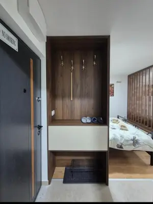a room with a bed and a door with shoes at Avalon apartments in Kopaonik