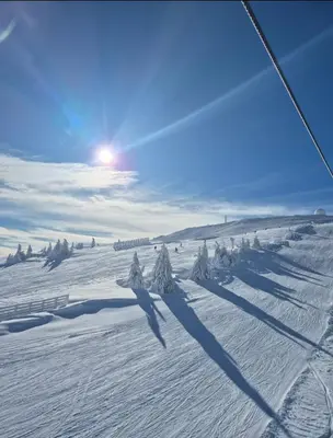 a shadow of a skier on a snow covered slope at Avalon apartments in Kopaonik