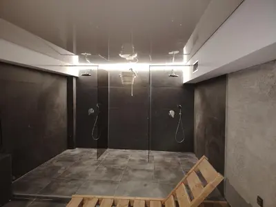 a bathroom with a shower with a glass door at Epic Apartments in Kopaonik