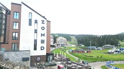 a view of a resort with a large building at Apartman Stotka in Kopaonik