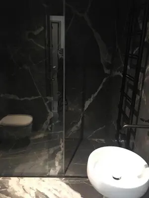a bathroom with a shower and a toilet and a sink at Apartman Stotka in Kopaonik