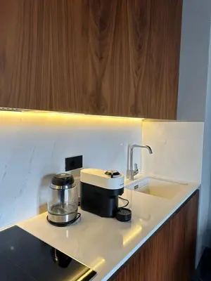 a kitchen counter with a sink and a coffee maker at Apartman Stotka in Kopaonik