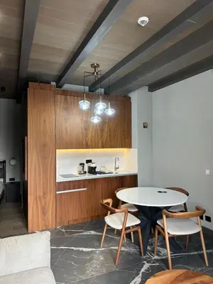 a kitchen with a table and chairs in a room at Apartman Stotka in Kopaonik