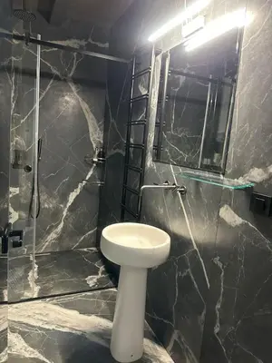 a bathroom with a white toilet and a mirror at Apartman Stotka in Kopaonik