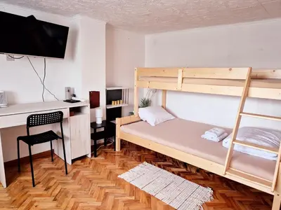 a bedroom with a bunk bed and a desk at Temački amanet in Pirot