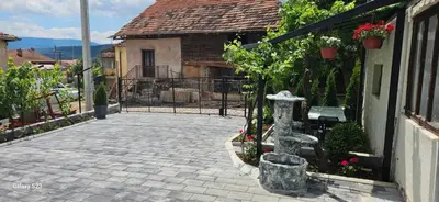 a stone walkway with a statue in front of a building at Temački amanet in Pirot