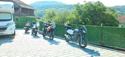 a row of motorcycles parked next to a fence at Temački amanet in Pirot