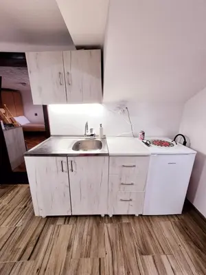 a kitchen with white cabinets and a sink at Temački amanet in Pirot